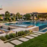 Swimming pool and jacuzzi with pergola and landscaped garden at a Dubai villa